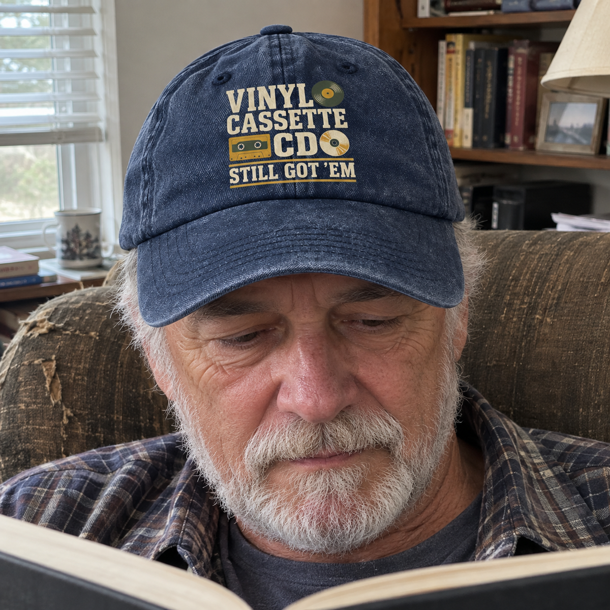 Vintage washed cap with printed “Vinyl Cassette CD Still Got ’Em” worn by senior man
