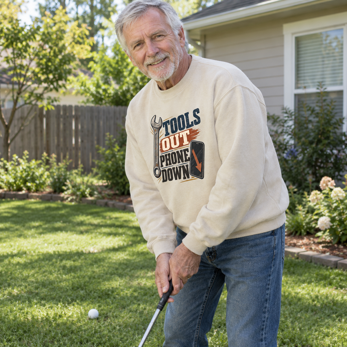 Cream vintage sweatshirt with Tools Out. Phone Down print worn by senior man golfing outdoors