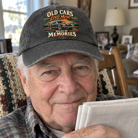 Senior man indoors wearing charcoal vintage washed cap with printed car and memories slogan.