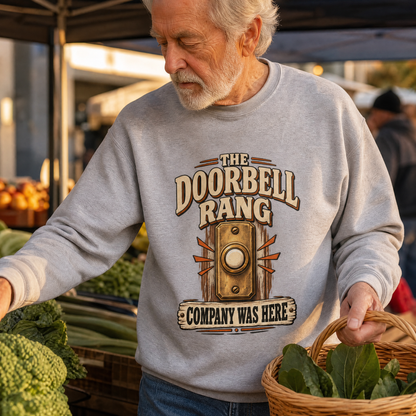 Senior man wearing gray vintage sweatshirt with printed doorbell design at outdoor market.