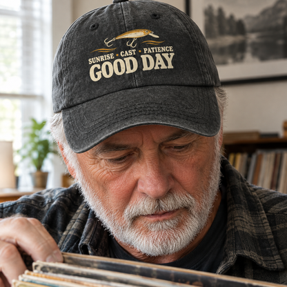 Senior man wearing black vintage washed cap with printed fishing slogan, lifestyle view.