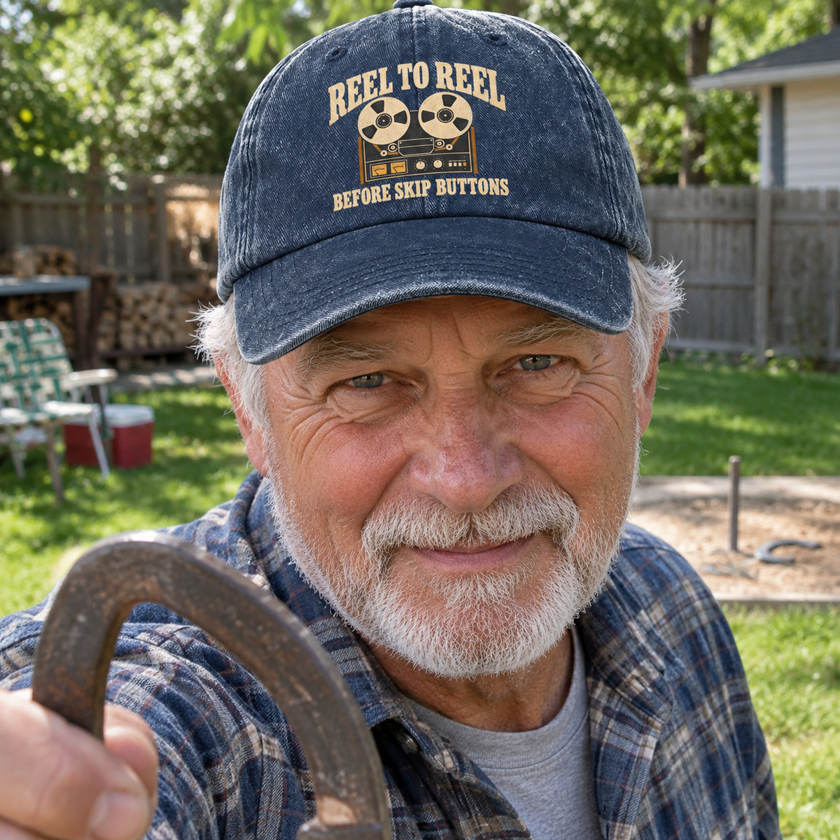 Senior man wearing navy vintage washed cap with printed Reel To Reel design outdoors