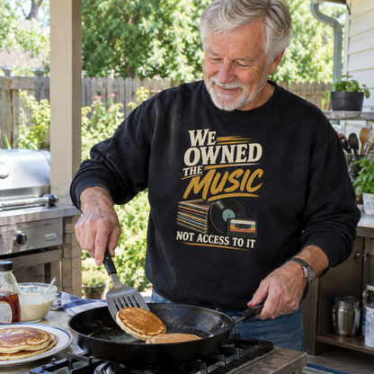 Senior man wearing black vintage sweatshirt with printed We Owned The Music slogan