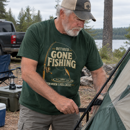 Dark green vintage t-shirt with printed Retired Gone Fishing design worn by senior man camping.