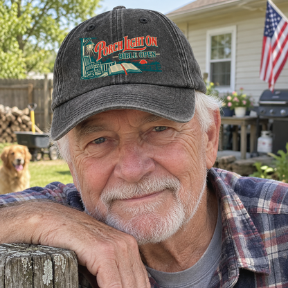 Senior man outdoors wears charcoal vintage washed cap with printed Porch Light On Bible Open
