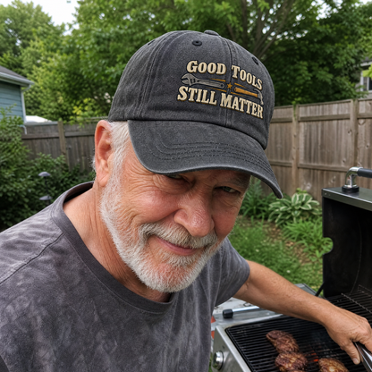 Vintage washed cap with printed Good Tools Still Matter design, worn by senior man outdoors