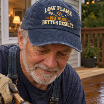 Vintage washed cap with printed Low Flame No Rush Better Results, worn by senior man