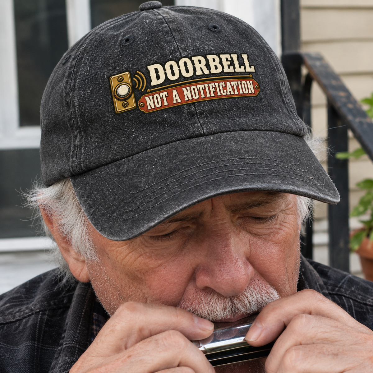 Black vintage washed cap with printed Doorbell. Not A Notification design, worn by senior man outdoors