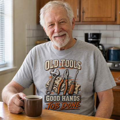 Gray vintage t-shirt with printed Old Tools Good Hands Job Done slogan on elderly man