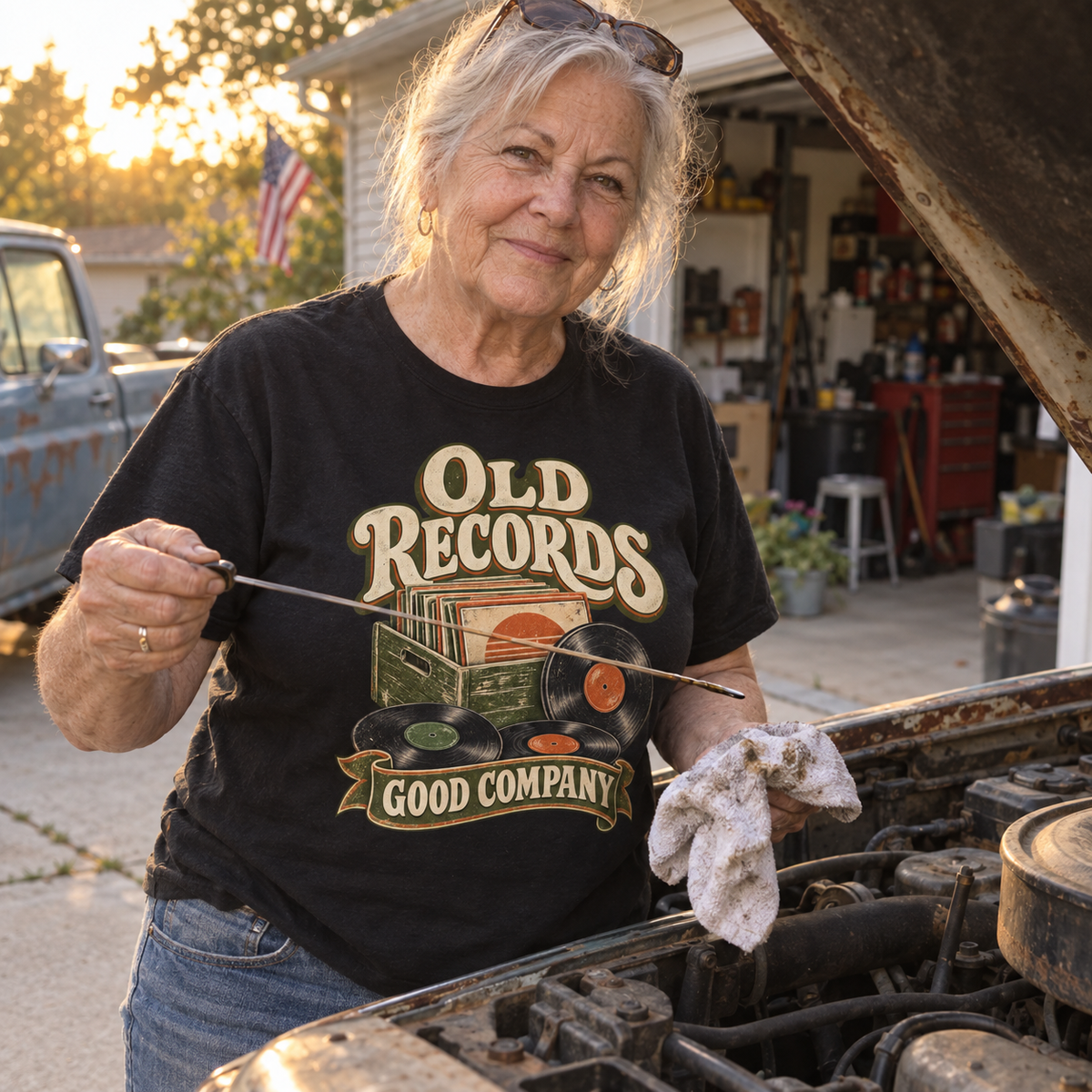 Senior woman wearing black vintage t-shirt with printed Old Records Good Company design by car.