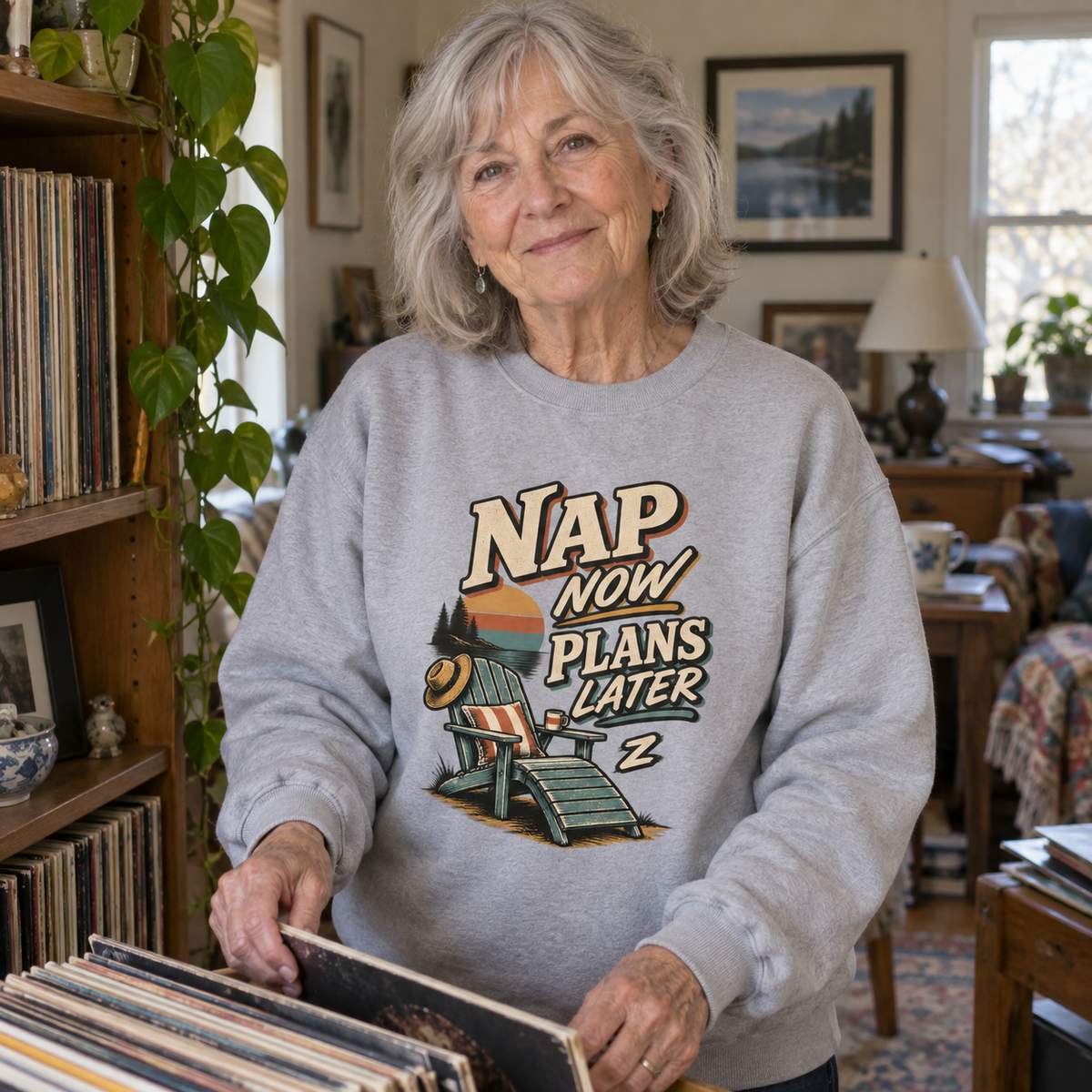 Senior woman browsing records wears gray vintage sweatshirt with printed Nap Now Plans Later design