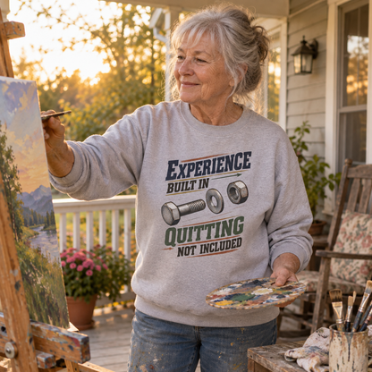 Senior woman painting in gray vintage sweatshirt printed Experience Built In Quitting Not Included.