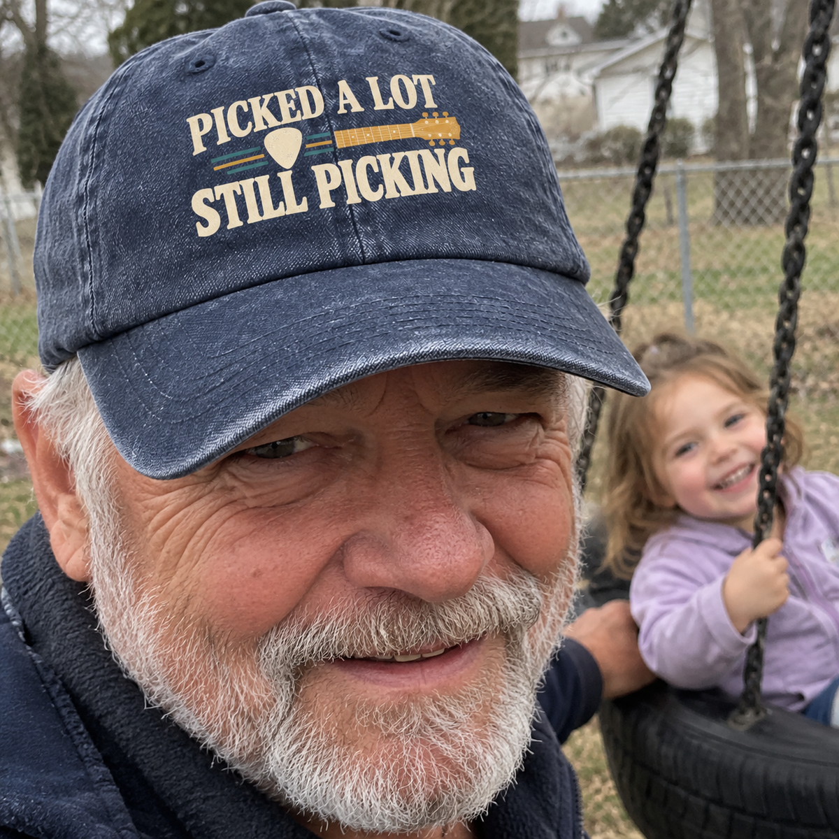Vintage washed cap with printed “Picked A Lot Still Picking” slogan, lifestyle close-up.
