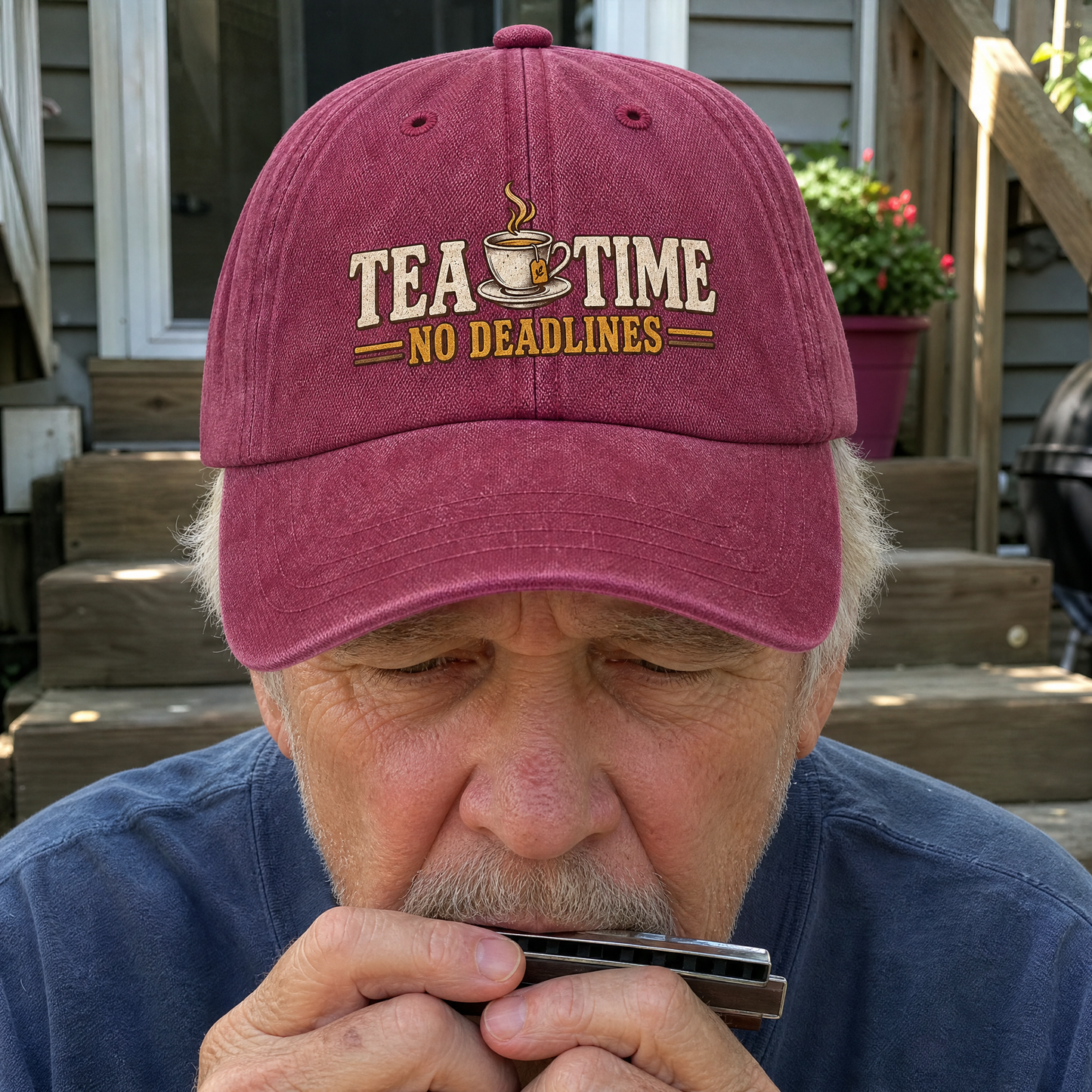 Senior man wearing a burgundy vintage washed cap with printed Tea Time. No Deadlines slogan