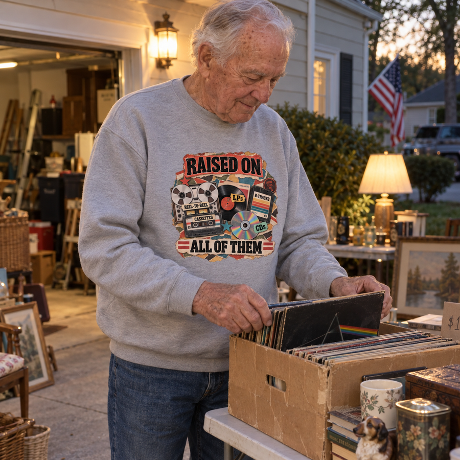 Senior man browses records wearing gray vintage sweatshirt printed with Raised On All Of Them