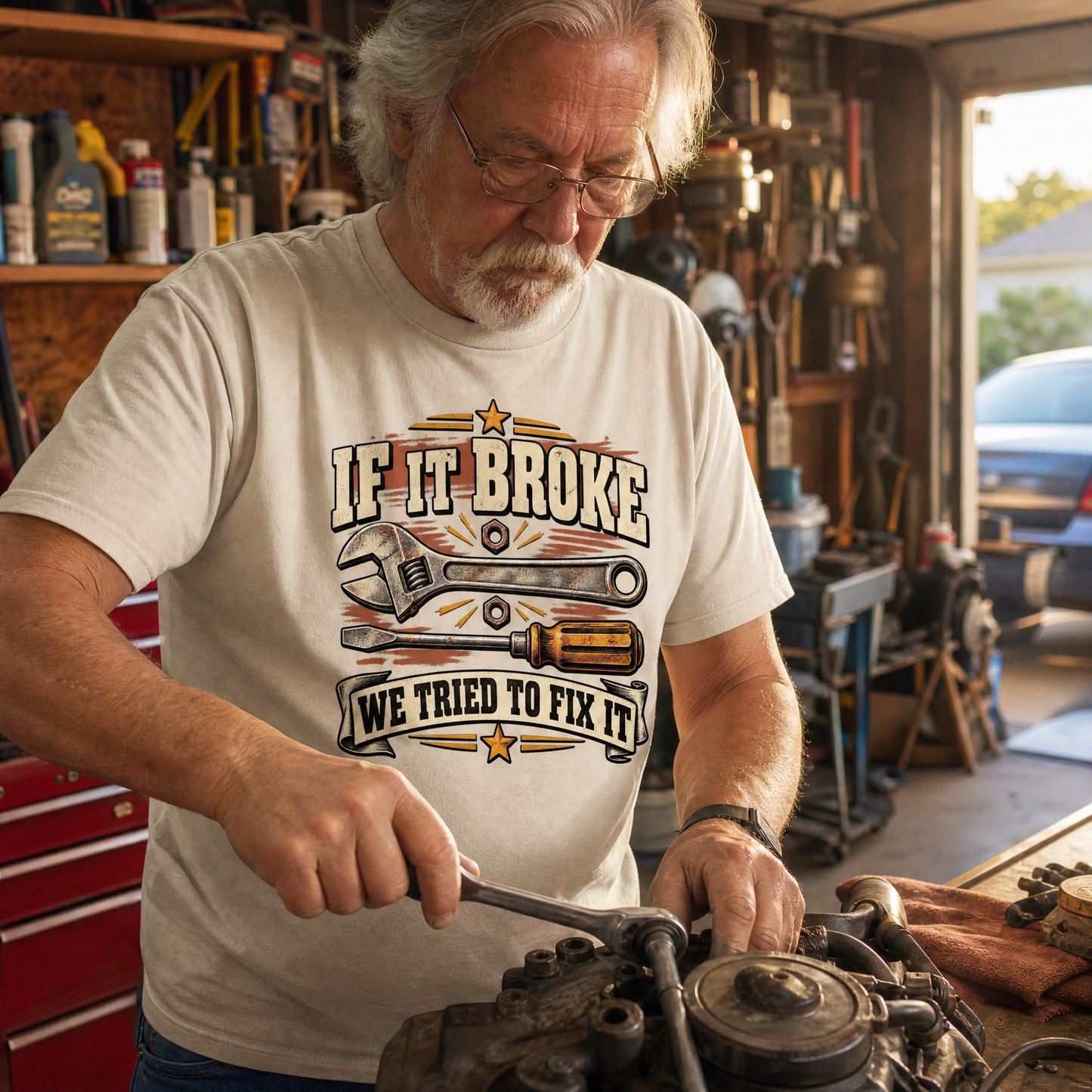 Vintage t-shirt with “If It Broke We Tried To Fix It” printed, senior man in workshop