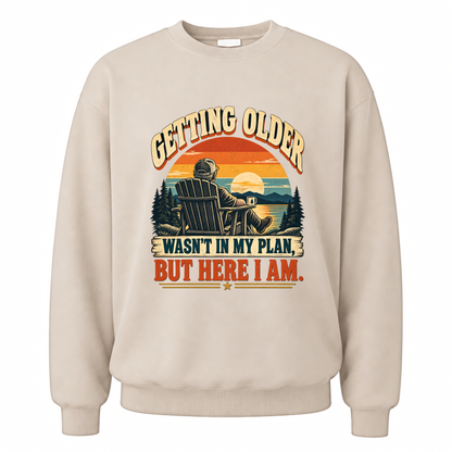 Sand vintage sweatshirt with Getting Older Wasn't In My Plan, But Here I Am. printed front design