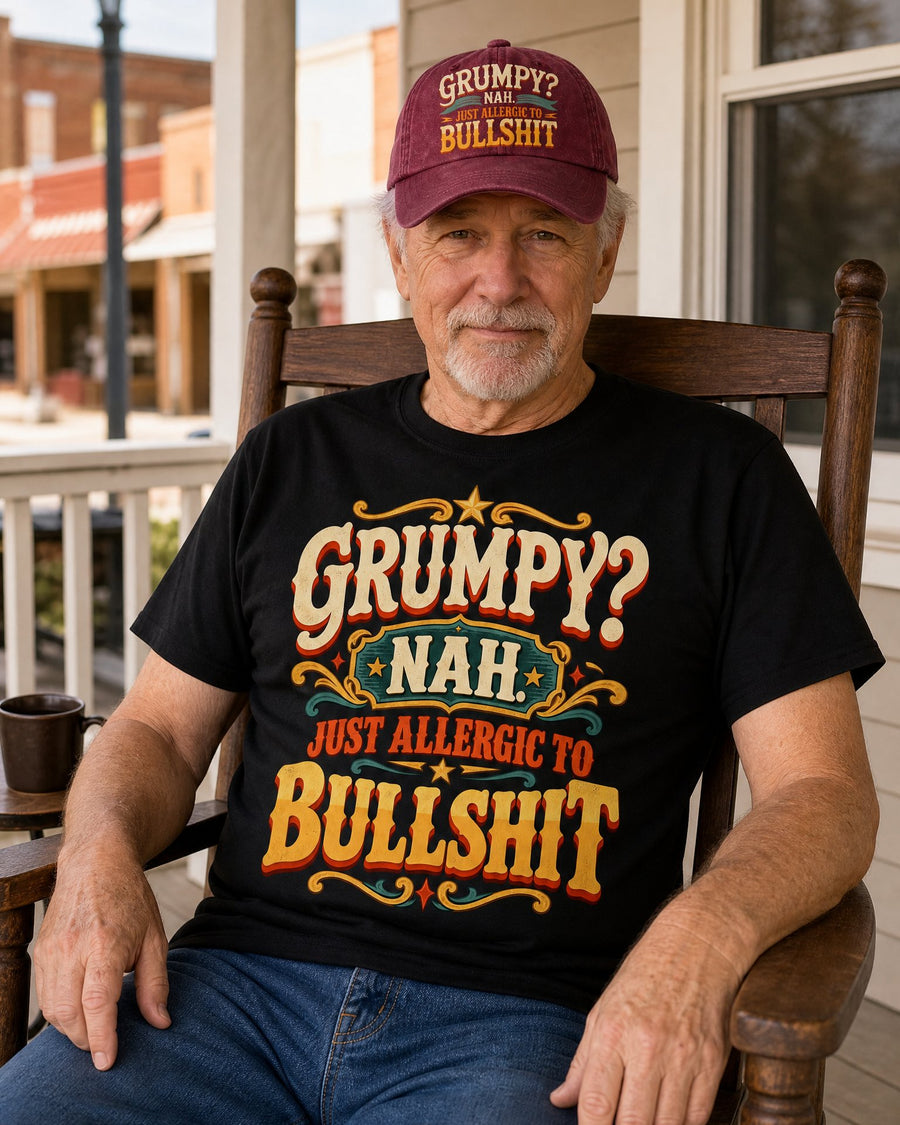 Man in the Grumpy? Nah black tee and wine red cap in a rocking chair on his porch, giving a knowing half-smile