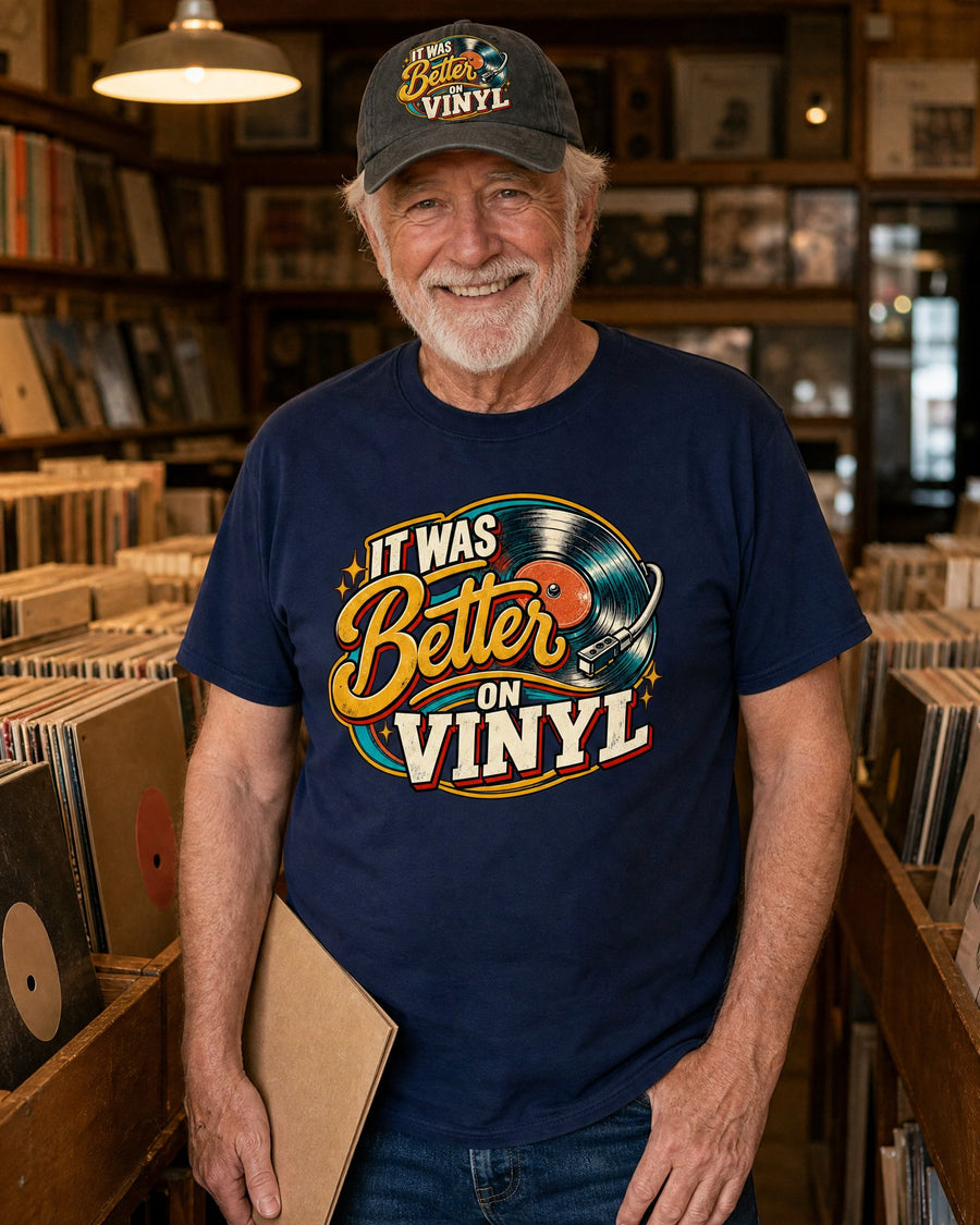 Man in the It Was Better On Vinyl navy tee and black cap in a record store aisle