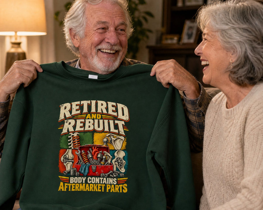 A wife watching her husband hold up the forest green sweatshirt he just unwrapped